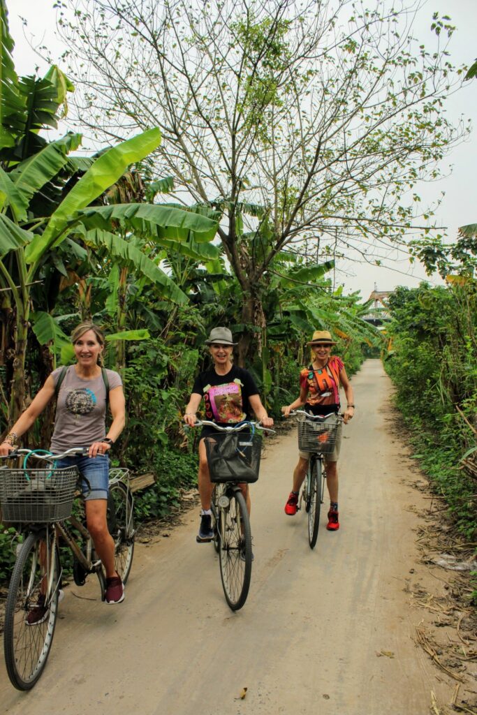 a group of people riding on the back of a bicycle