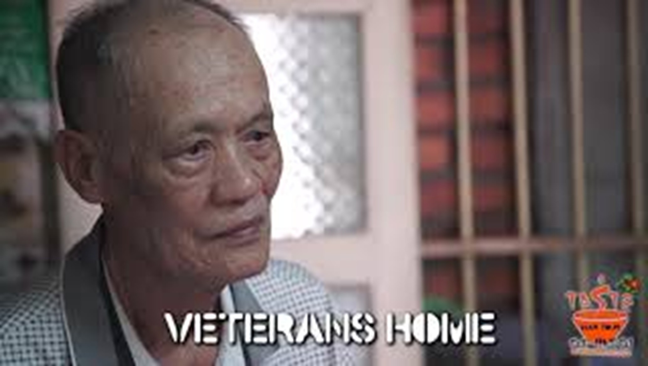 Elderly man with gray hair in a room, text: 'Veterans Home'.