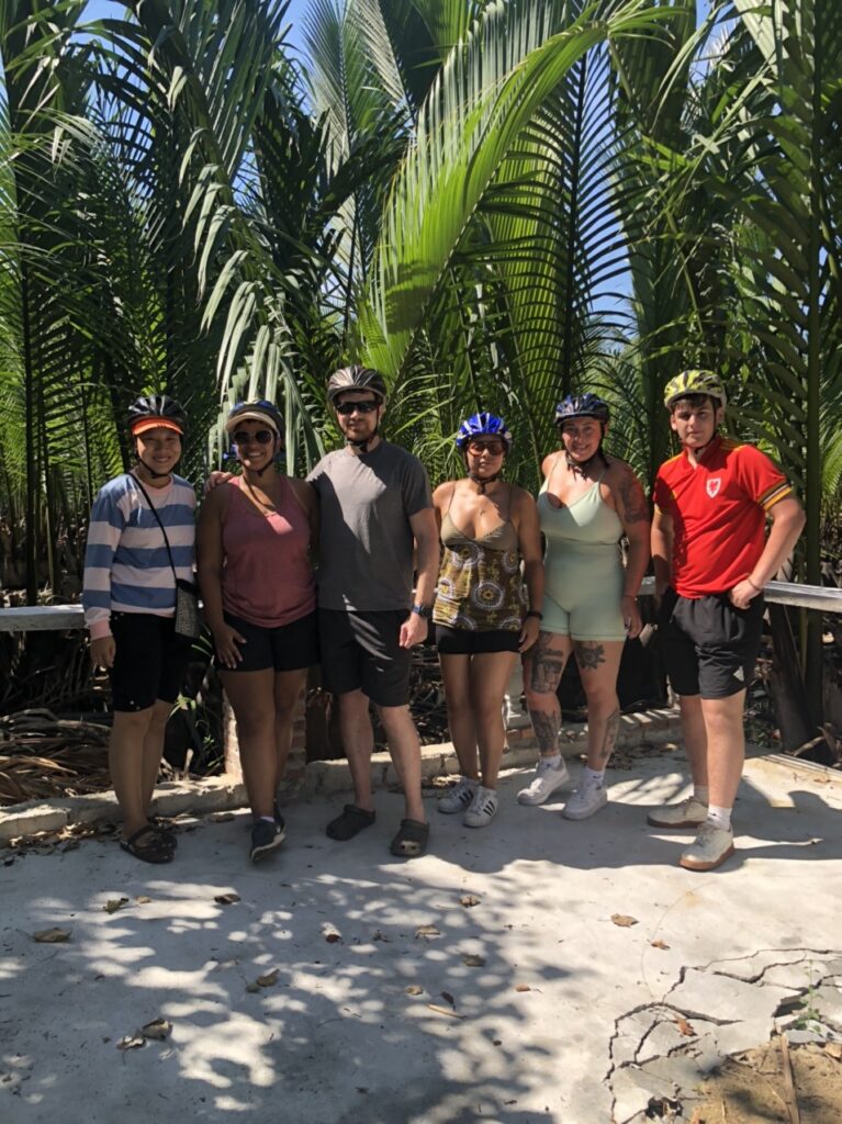a group of people standing next to a tree